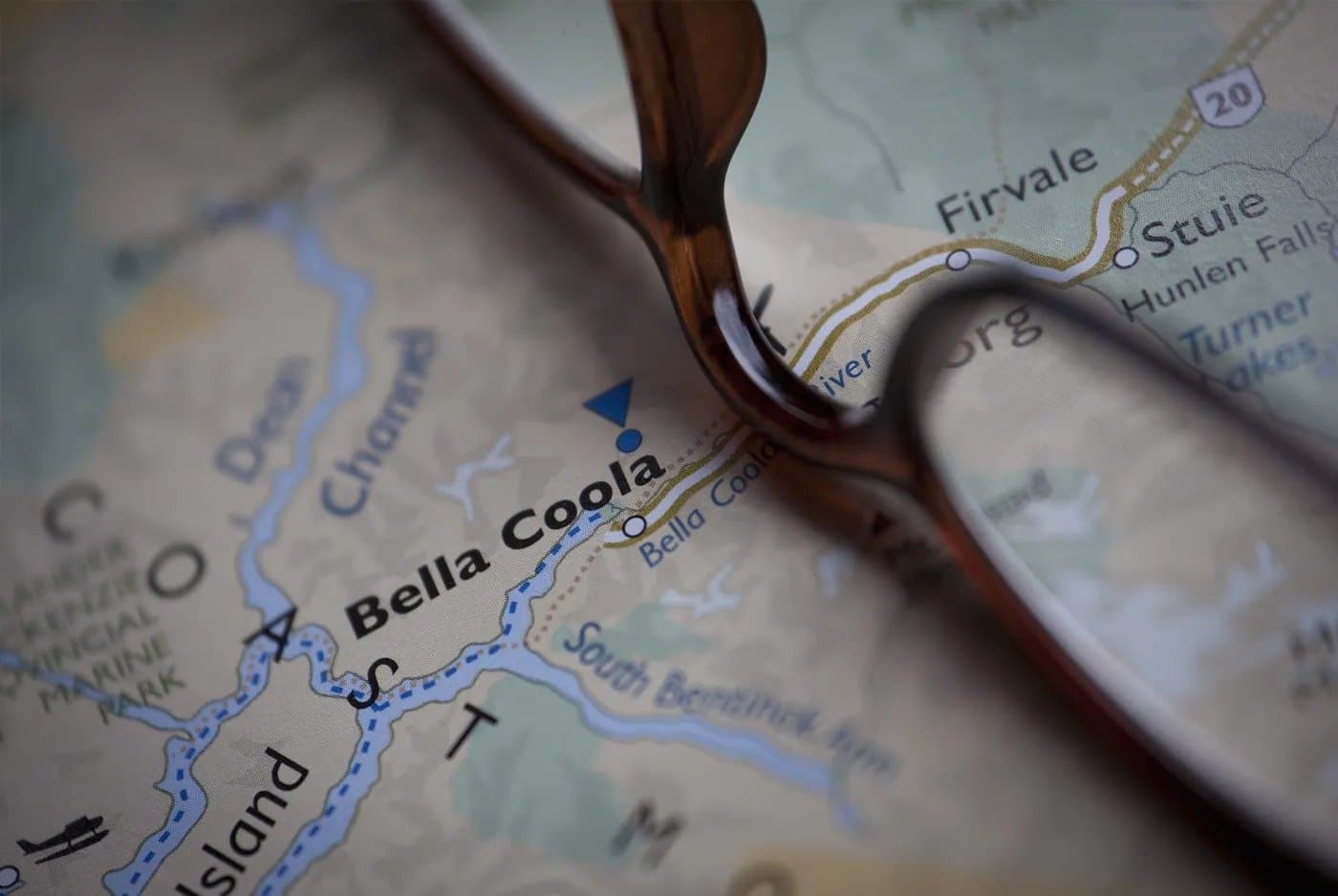 A pair of glasses sitting on a map