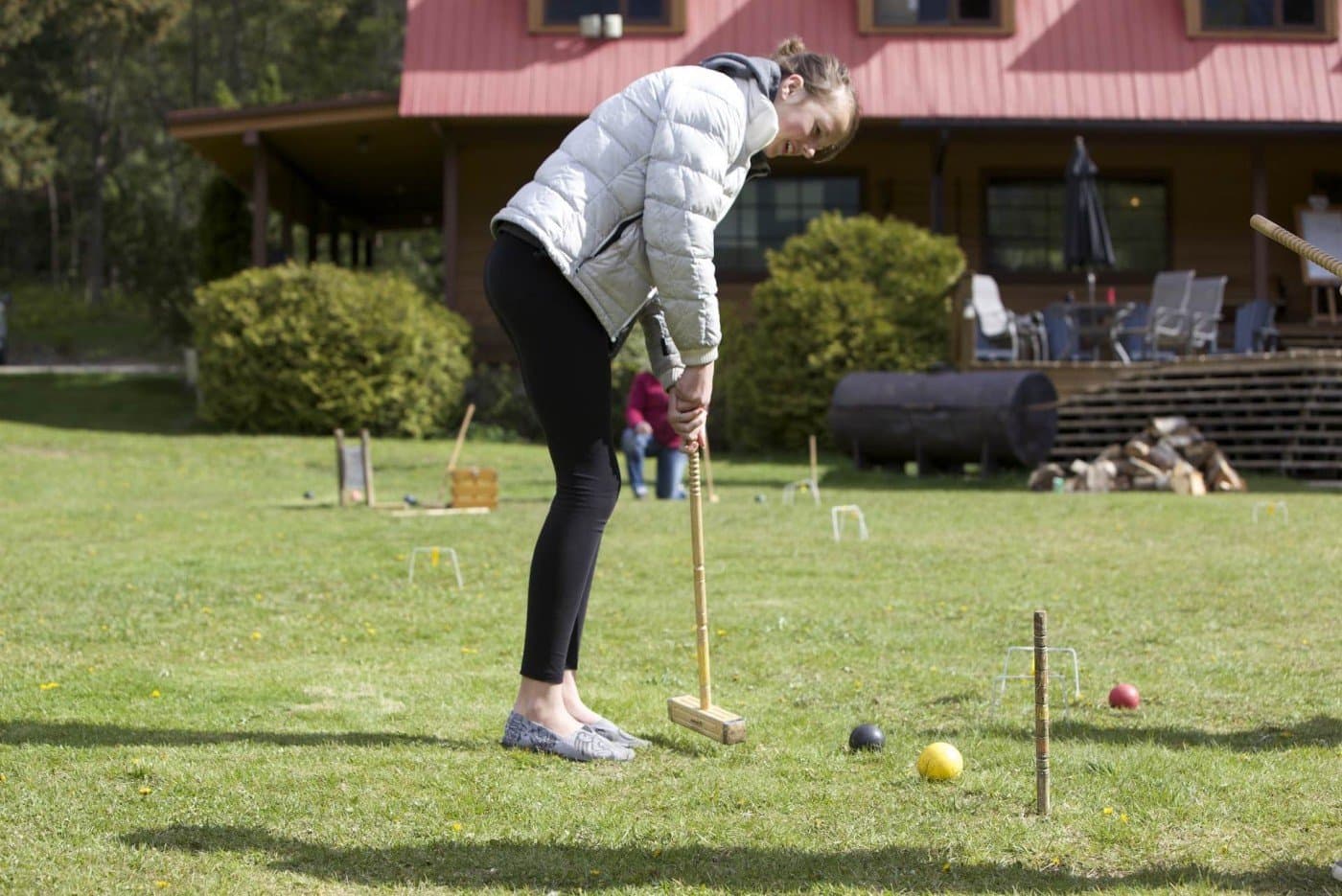 A woman playing lawn games