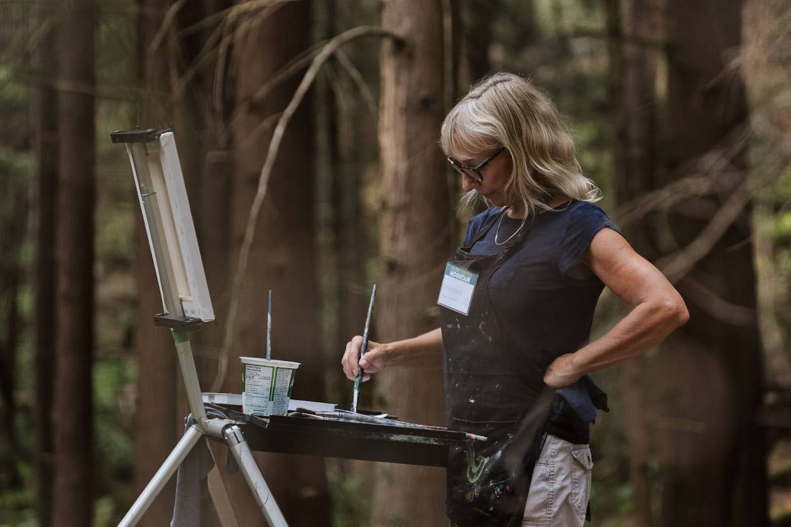 Susie Cipolla painting in the woods
