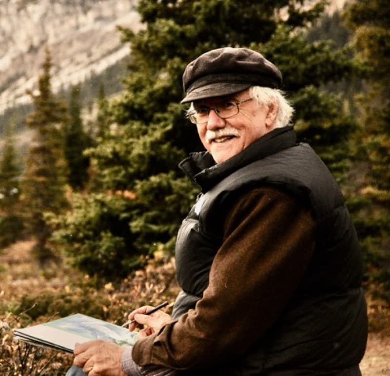 A photo of Mark Hobson drawing in the mountains