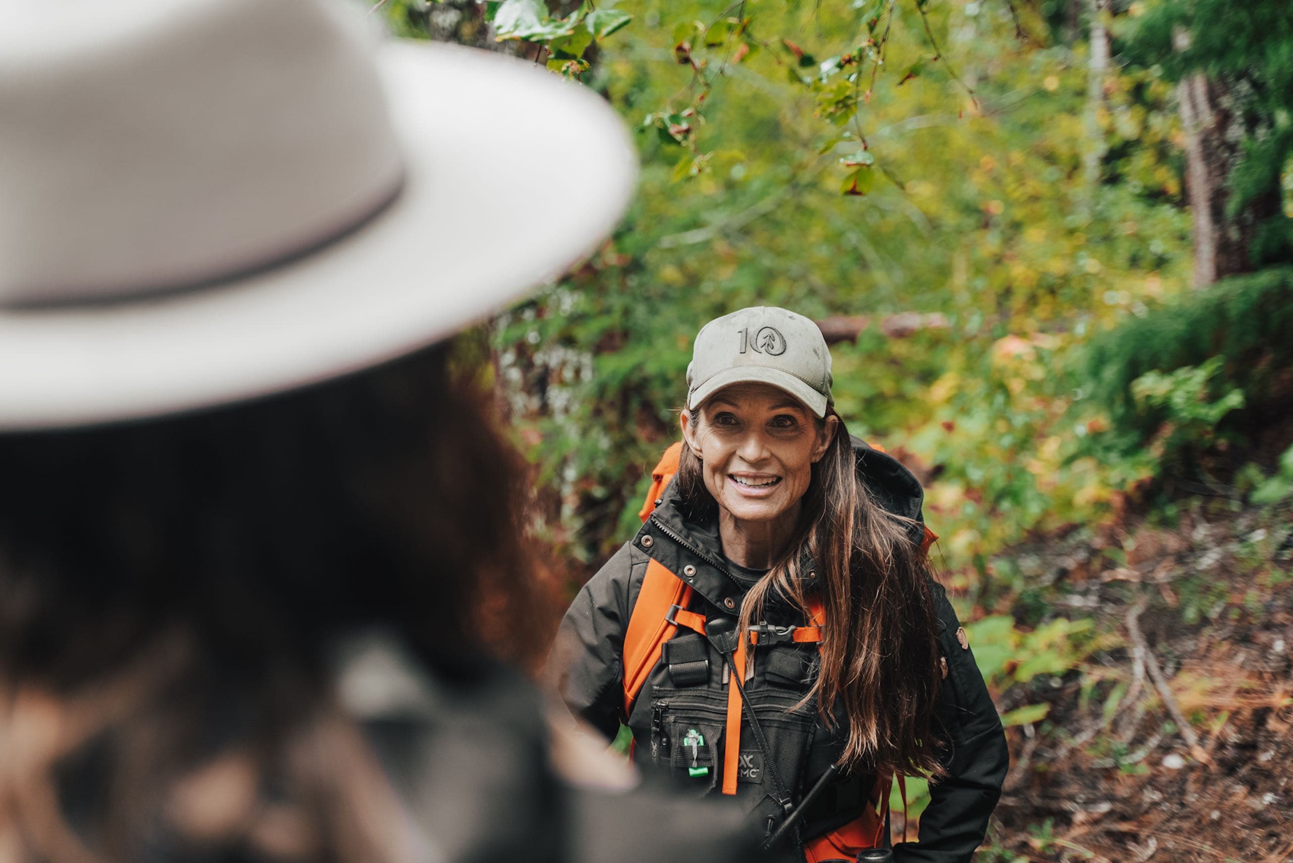 A woman leading a group in the woods