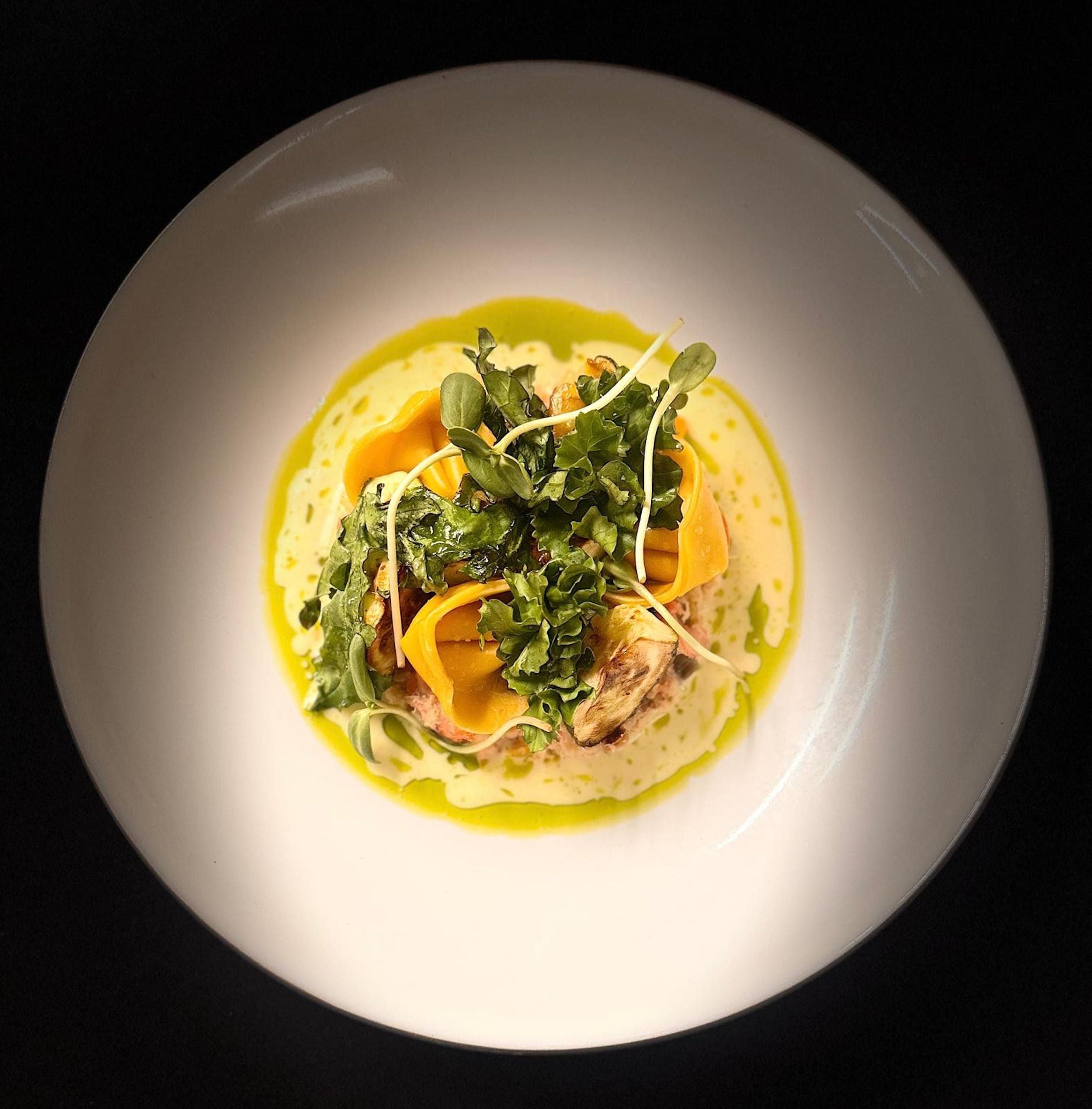 A white plate with a green and yellow dish